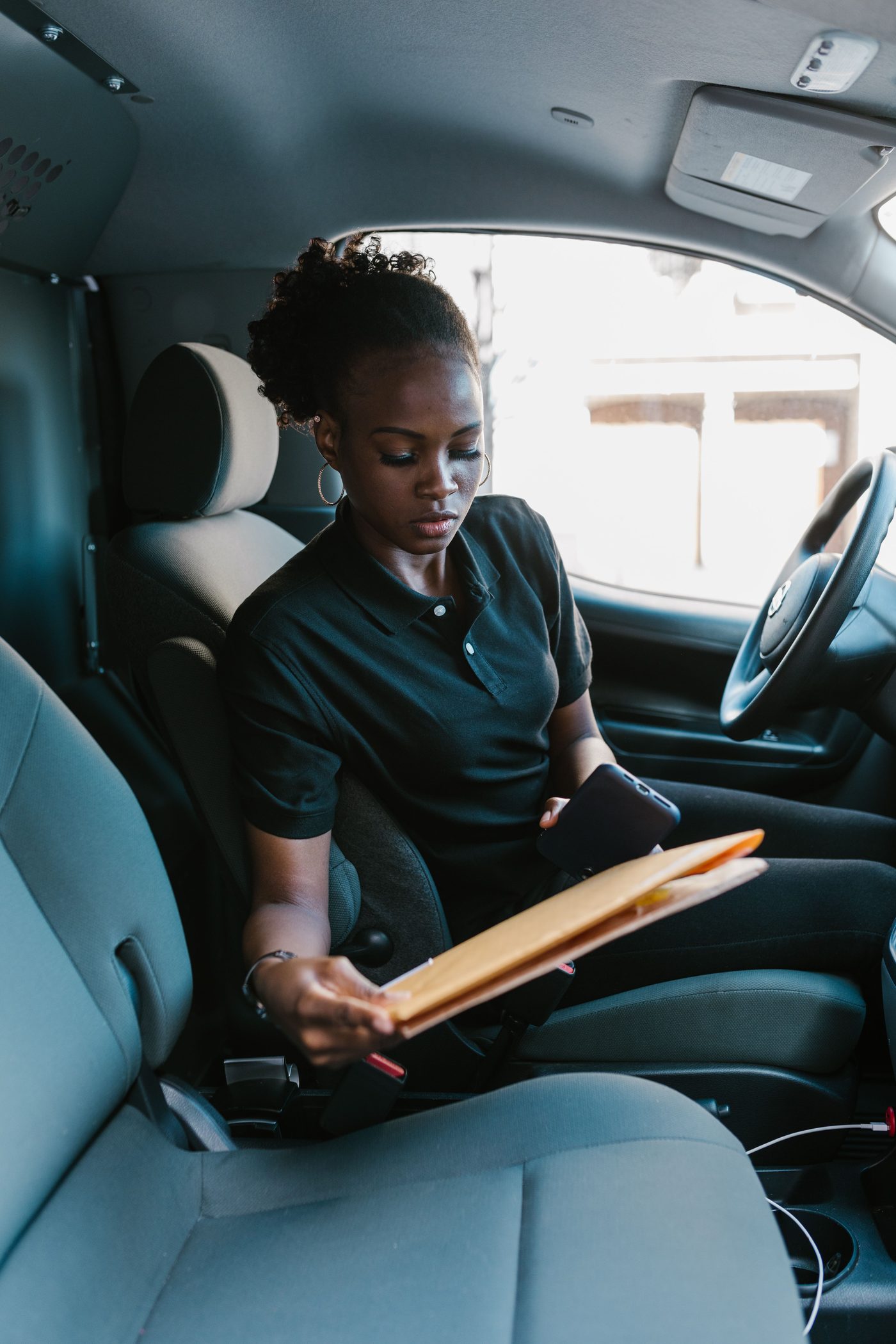 Driver checking a delivery in the van